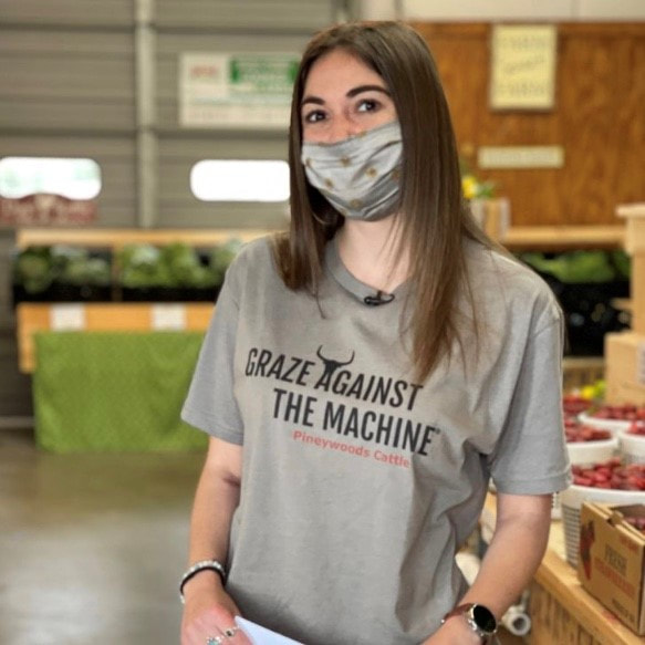 Ariana at a farmers market wearing the original Graze Against The Machine t-shirt design