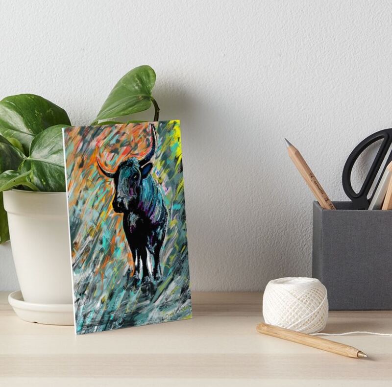 An art board print of Rocky, Pineywoods Bull Abstract Painting sitting on a table 